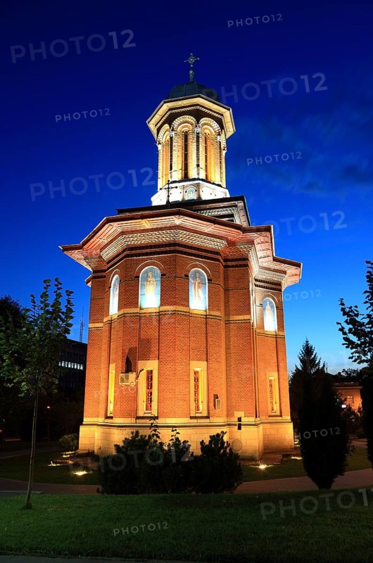 Illuminated church at night with a high tower, blue sky and visible windows. Craiova, Krajowa, Kragau, Church of St Treime, Holy Trinity Church, Bisceria Sfanta Treime, Small Wallachia, Romania, Europe