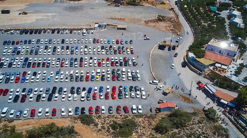 Overtourism, aerial view of a large car park with many parked cars, surrounding streets and buildings, Elafonissi, lagoon, southwestern tip of Crete, Crete, Greek Islands, Greece, Europe