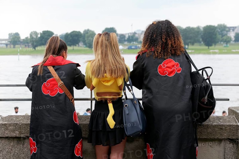 Three costumed woman looking at the Rhine, back view, cosplay at Japan Day Düsseldorf, North Rhine-Westphalia, Germany, Europe