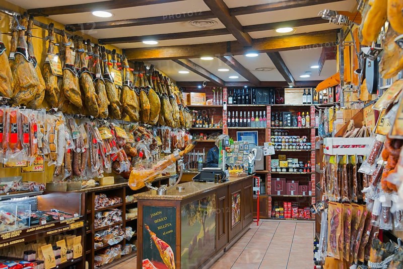 A rustic shop filled with hanging hams and other foods on the shelves, Plasencia, Cáceres, Caceres, Extremadura, Spain, Europe