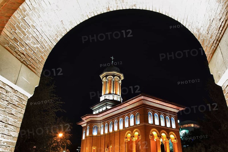 Illuminated church at night with a high tower, blue sky and visible windows. Craiova, Krajowa, Kragau, Church of St Treime, Holy Trinity Church, Bisceria Sfanta Treime, Small Wallachia, Romania, Europe