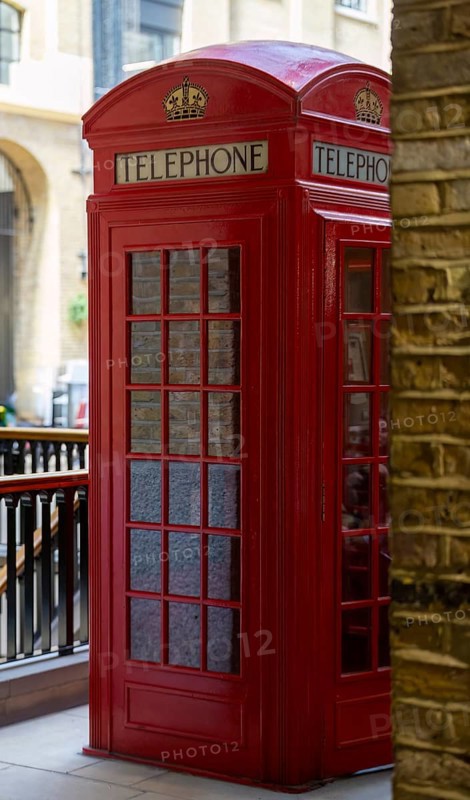 Historic red telephone box in a canopied street scene, stylised and classically British, London, United Kingdom Great Britain