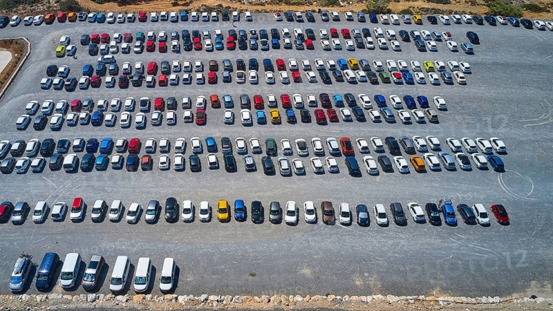 Overtourism, aerial view of a large car park with numerous vehicles parked in order, in sunny weather, Elafonissi, lagoon, southwestern tip of Crete, Crete, Greek Islands, Greece, Europe