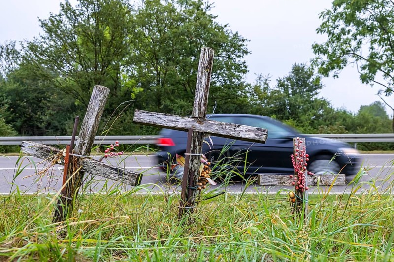 Cross on a country road, symbol of remembrance for three road accident victims. Laichigen, Baden-Württemberg, Germany, Europe