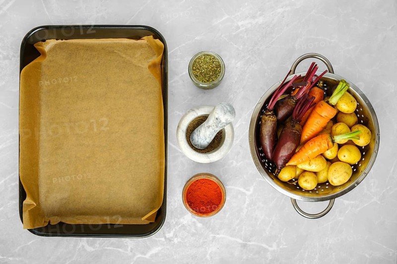 Overhead view of fresh vegetables and spices for baking on kitchen countertop