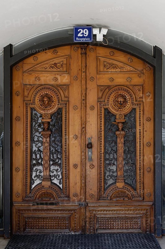 Decorative antique wooden door with ornate carvings, main square 29, Villach, Carinthia, Austria, Europe