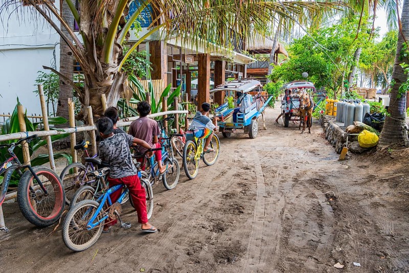 Everyday life on the island road, children, street scene, holiday, tourism, tradition, culture, Gili Air, Indonesia, Asia
