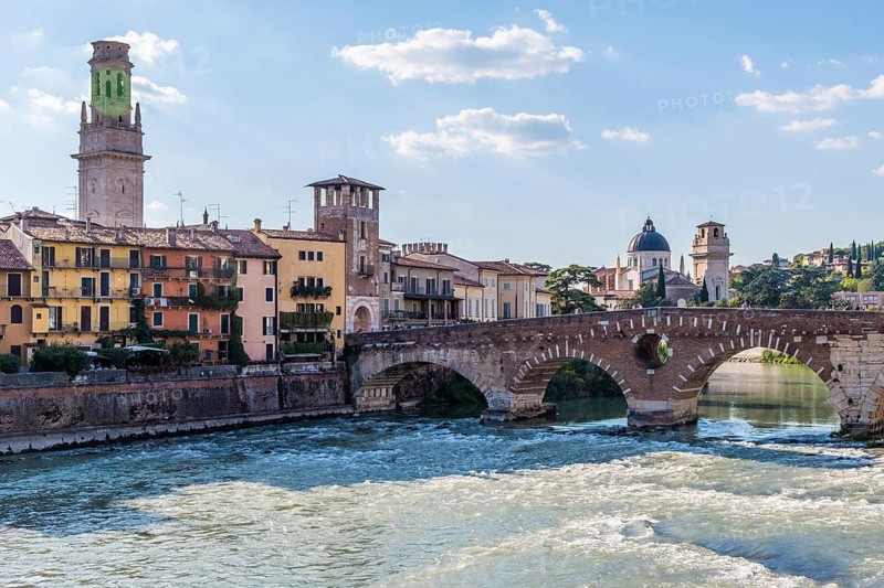 View of Verona historical city centre, Ponte Pietra bridge across Adige river, Verona Cathedral, Duomo di Verona, red tiled roofs, Veneto Region, Italy. Verona cityscape, panoramic view