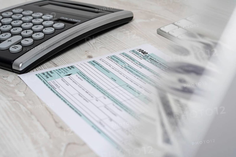 US tax form 1040 with pen and calculator. tax form law document usa white mathematics business concept