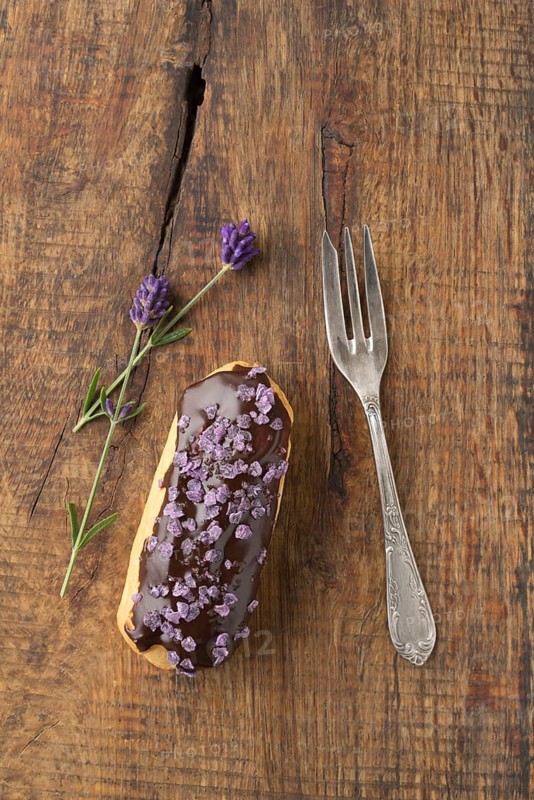 Eclair with chocolate ganache with candied lavender topping