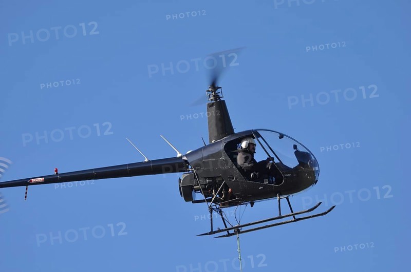 Helicopter lifts a load for a job in Westland, New Zealand, Oceania