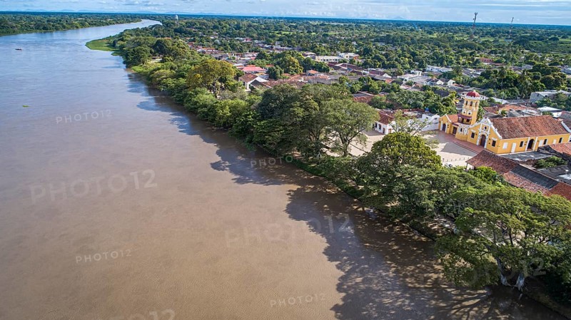 Aerial view of the historic town Santa Cruz de Mompox in sunlight with river and Iglesia De Santa Bárbara (church of Saint Barbara) Colombia, World Heritage