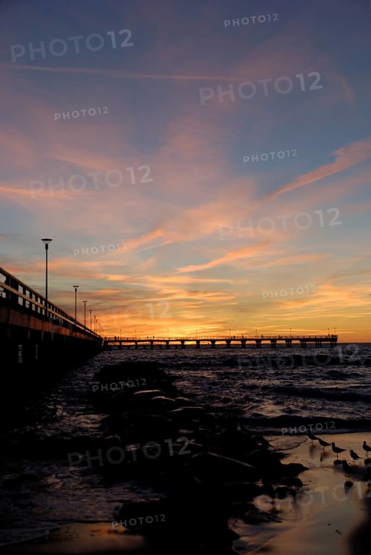 Sunset at the pier on the beach in Palanga, Lithuania, Europe