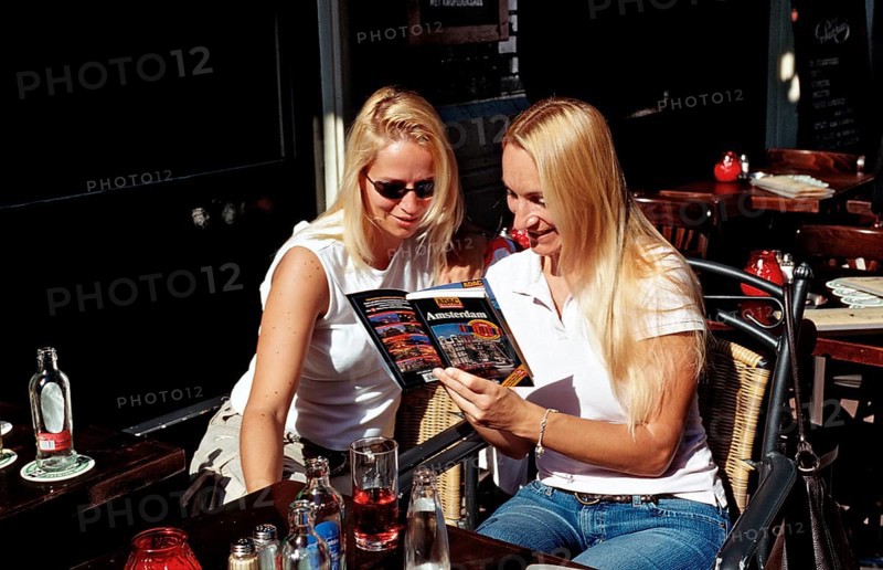 Two tourists reading a travel guide, Netherlands, Holland, Amsterdam