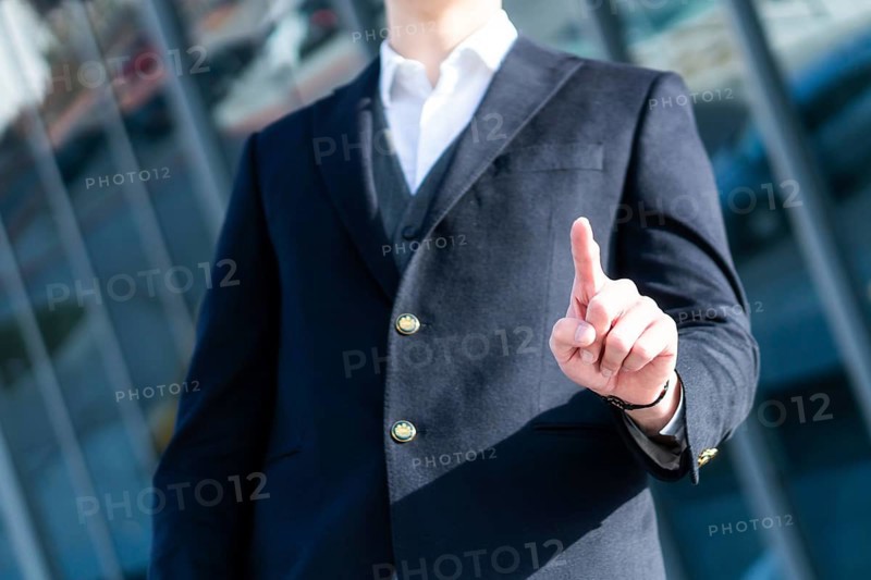 Photo of Business Man pushing on a touch screen interface