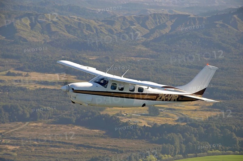 Single engined light aircraft flying over Westland, New Zealand, Oceania