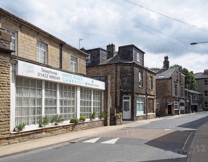 Mytholmroyd, west yorkshire, united kingdom, 13 july 2019: new road in mytholmroyd west Yorkshire with the office of the white ribbon charity shops and houses