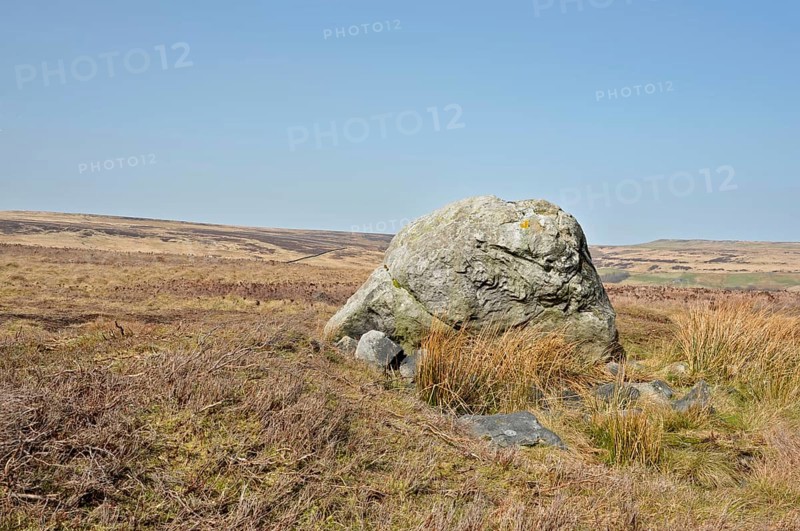 Pennine landscape with large old boulder or standing stone on midgley moor in west yorkshire