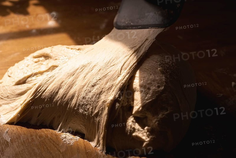 Bread sourdough on a kitchen counter in natural light. Close-up of white flour dough. Fermented dough