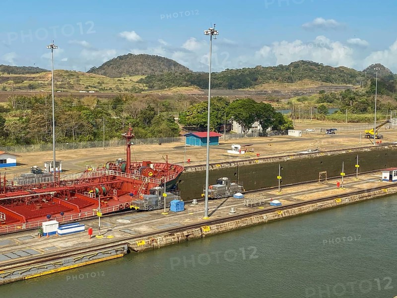 Ship in a lock in a canal, surrounded by industrial buildings, panama city, panamakanl, panama, Central America