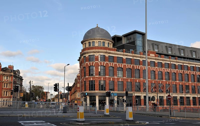 Leeds, England, January 11, 2018: man crossing the road and traffic on new york road and north street in leeds
