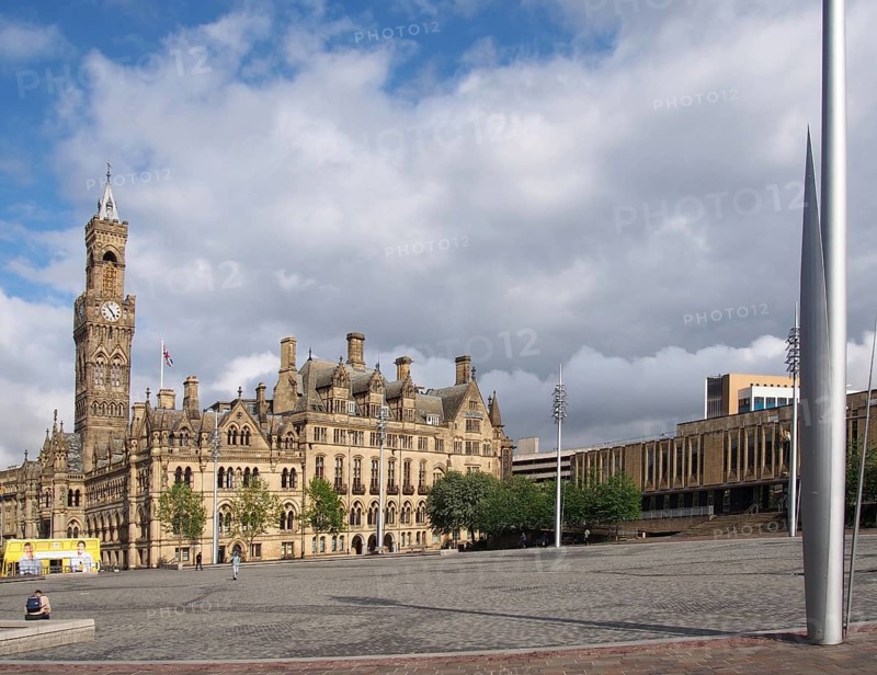 Bradford, west yorkshire, united kingdom, 28 may 2019: centenary square in bradford west yorkshire with people sitting and walking past the city hall and magistrates court buildings