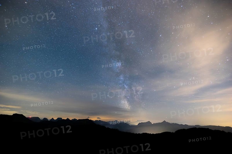 Clear starry sky with visible Milky Way and mountains in the background, Hochalp, Urnäsch, Appenzell Ausserrhoden, Switzerland Mountain hut under a clear starry sky with visible Milky Way and mountains in the background, Hochalp, Urnäsch, Appenzell Ausserrhoden, Switzerland, Europe
