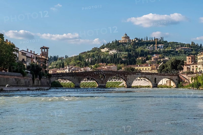 View of Verona historical city centre, Ponte Pietra bridge across Adige river, Verona Cathedral, Duomo di Verona, red tiled roofs, Veneto Region, Italy. Verona cityscape, panoramic view