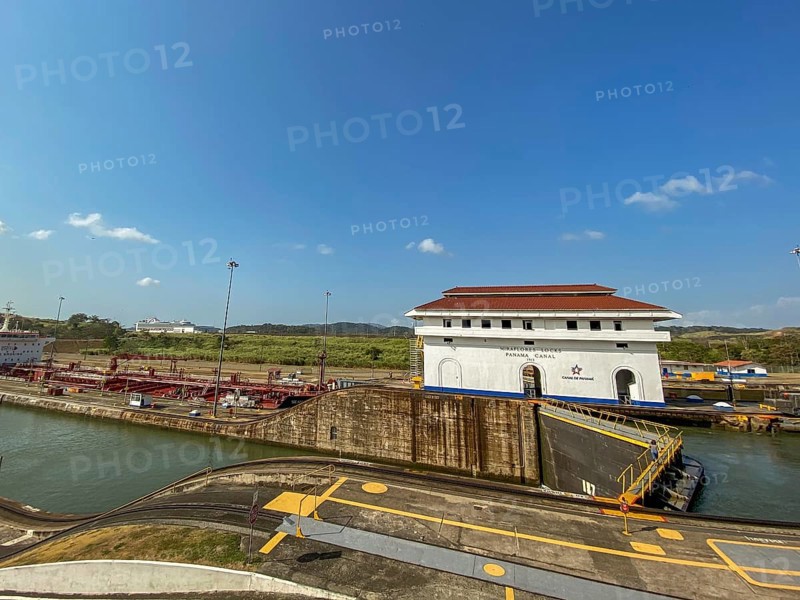 White lock building with red roof in an industrial canal area, panama city, panamakanl, panama, Central America