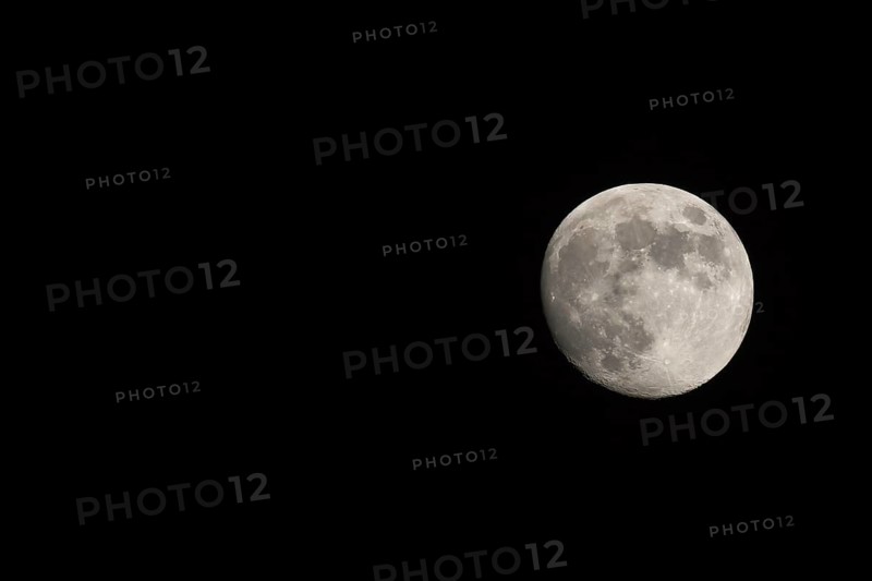 Waxing gibbous Moon, landscape orientated image with Moon isolated on black background with text or copy space
