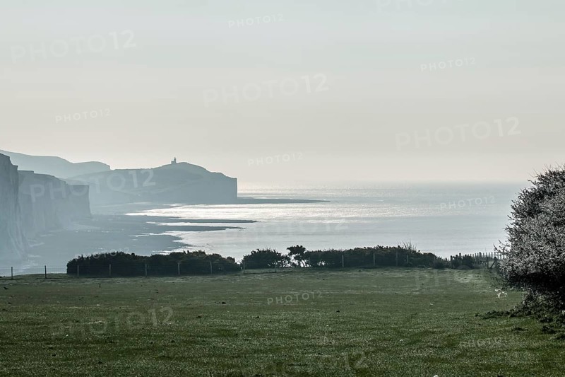 Belle Tout Lighthouse and Seven Sisters chalk cliffs from Seaford Head on April morning