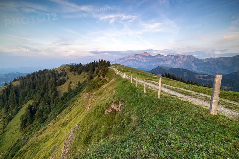 An impressive panorama of mountains with rocky peaks and dense forests under a cloudy sunset, Hochalp, Urnäsch, Appenzell Ausserrhoden, Switzerland, Europe