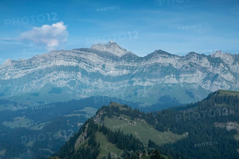 An impressive panorama of mountains with rocky peaks and dense forests under a cloudy sunset, Hochalp, Urnäsch, Appenzell Ausserrhoden, Switzerland, Europe