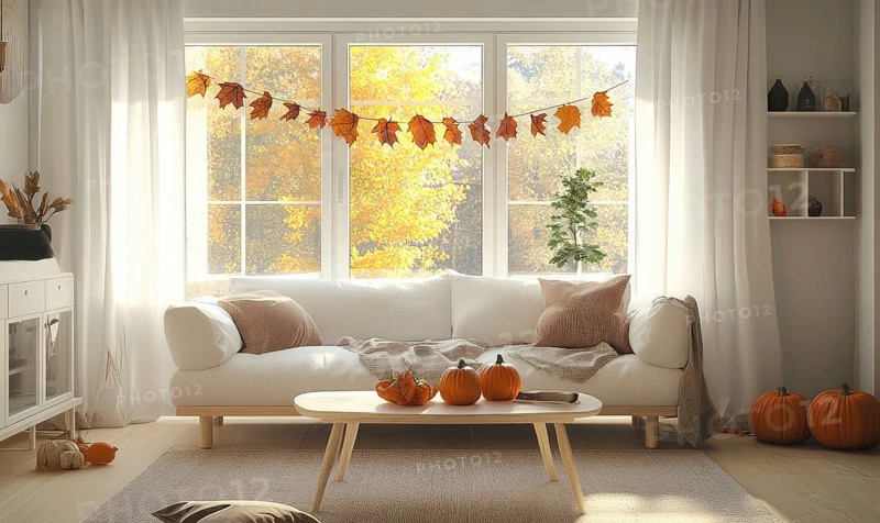 Scandinavian living room with a white sofa, light wooden coffee table, autumn leaves garland and pumpkins AI generated
