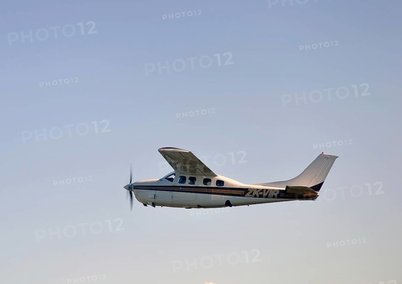 Single engined light aircraft flying over Westland, New Zealand, Oceania