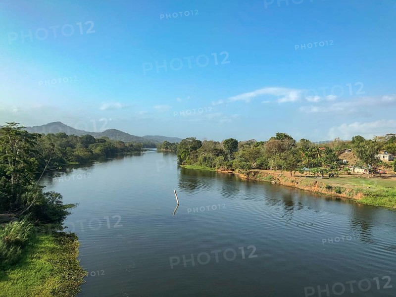 Calm river, surrounded by trees and mountains under a blue sky, panama city, panamakanl, panama, Central America