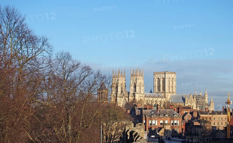 York, north yorkshire, united kingdom, 22 January 2020: a view of york minster from the city walls with people and traffic crossing lendal bridge