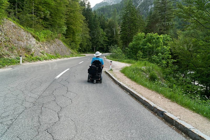 Disabled person in an electric wheelchair on the street