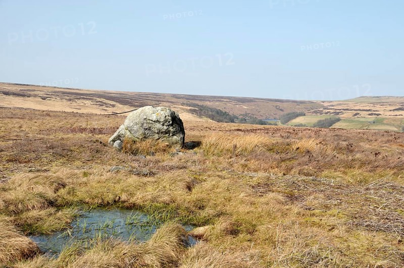 Pennine landscape with large old boulder or standing stone on midgley moor in west yorkshire