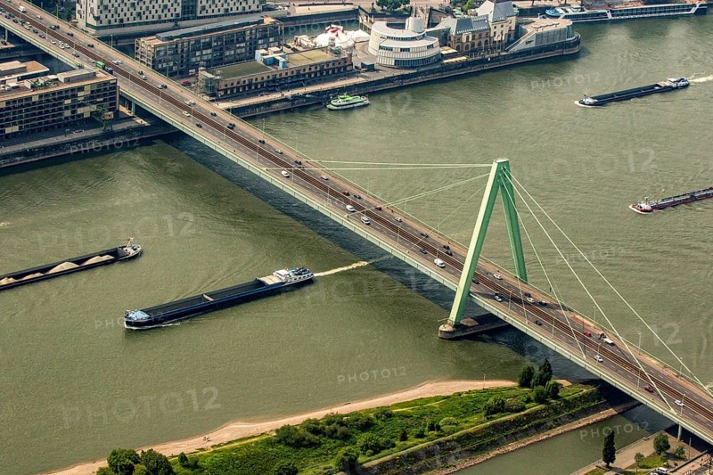 Ships on the Rhine pass under the Severin Bridge. Cargo ships, inland navigation