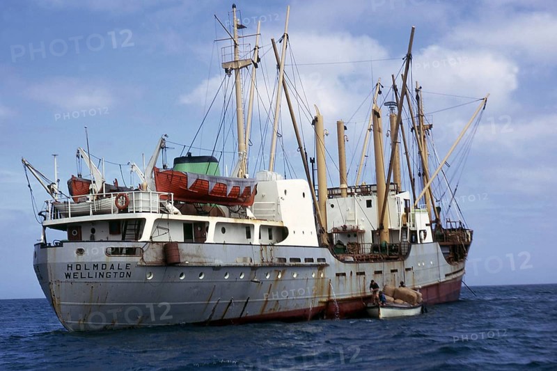 CHATHAM ISLANDS, SOUTH PACIFIC, CIRCA 1960: People transfer bales of wool from a small boat to the Holmdale for spipment to New Zealand circa 1960 in the Chatham Islands, South Pacific