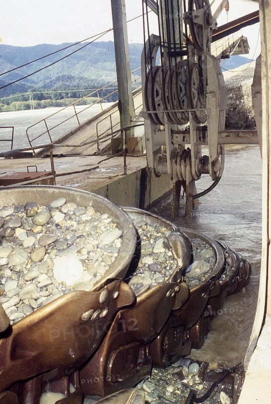 Bucket chain carries river bed gravel into the Ngahere Gold Dredge, West Coast, South Island, New Zealand, Oceania