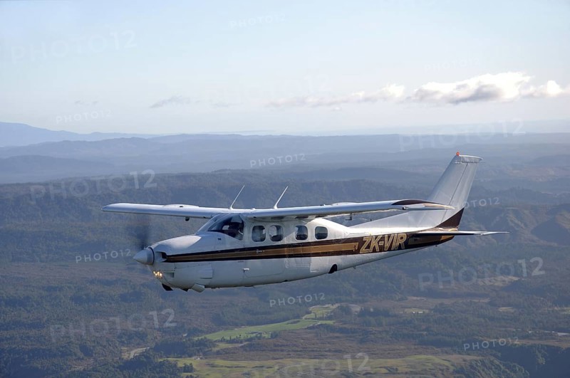 Single engined light aircraft flying over Westland, New Zealand, Oceania