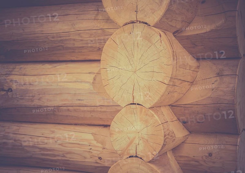 Architectural image with the exterior corner and part of the wall of a log house, traditional built from round wooden beams
