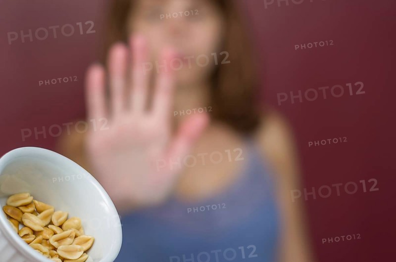 Great concept of food allergy, allergy to peanut, woman denying peanut
