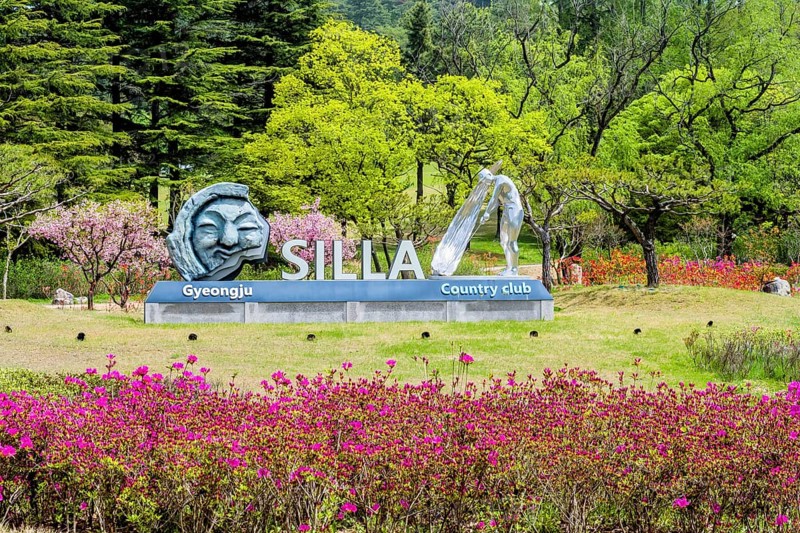 Silla Gyeongju Country Club sign surrounded by colorful flowers and green trees, indicating a beautiful spring environment in Gyeongju, South Korea, Asia