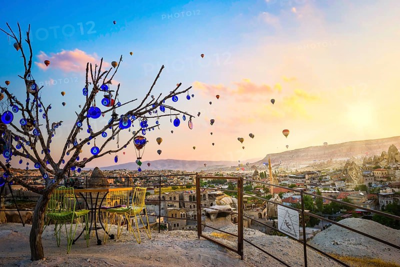 Dry tree with nazars amulets in Cappadocia at sunrise