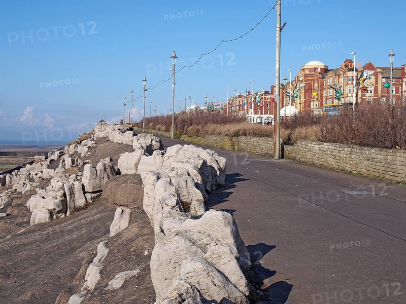 Blackpool, Lancashire, United Kingdom, 07 March 2020: The pedestrian walkway along the south promenade in Blackpool at the artificially landscaped area known as the cliffs with hotel buildings facing the sea, Europe