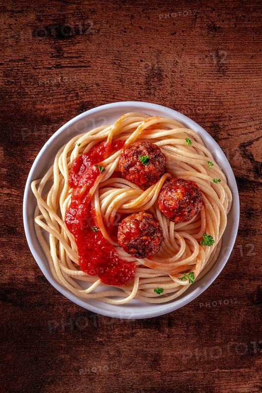 Meatballs. Beef meat balls, shot from above with spaghetti pasta, parsley, and tomato sauce, on a rustic wooden table, Food photography