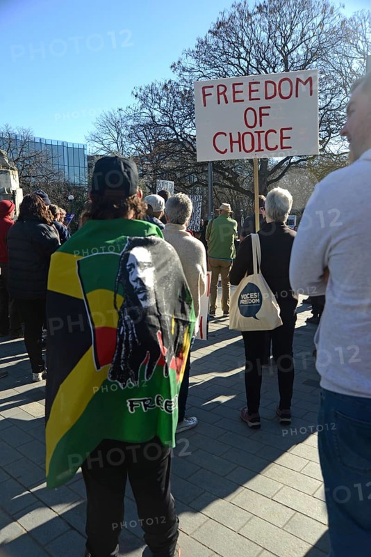 CHRISTCHURCH, NEW ZEALAND, JULY 24, 2021, People at a protest rally at the Bridge of Remembrance in Christchurch. Activists spoke against increasing government control over Covid vaccinations, farm taxes and civil liberties